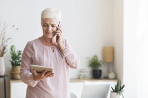 Life Assure Senior Woman On The Phone While Reading Tablet Blog